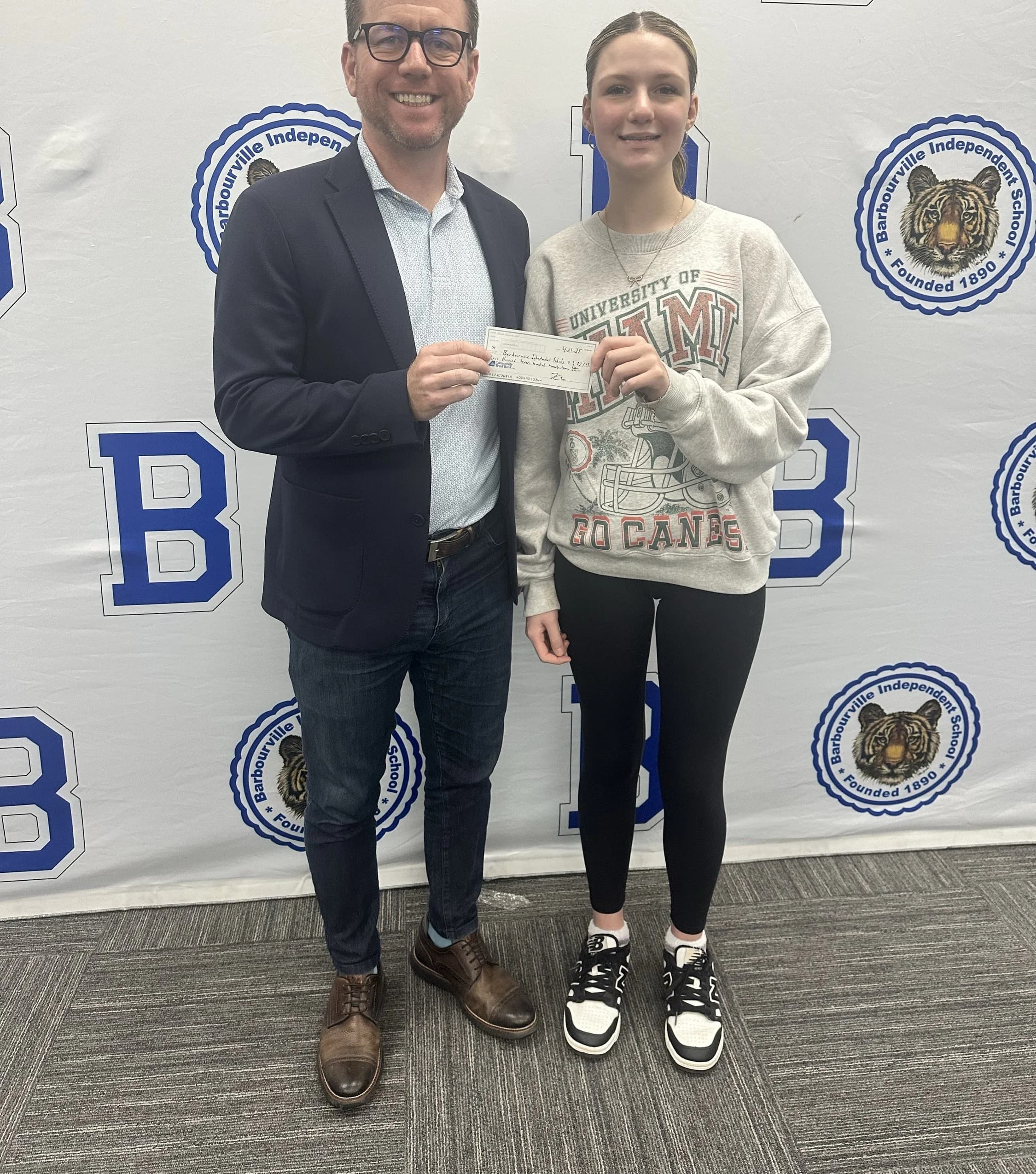 Student receiving Boom seed capital check